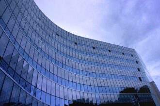 Fish Eye View Photo of Glass High Story Building over White Cloudy Sky during Daytime