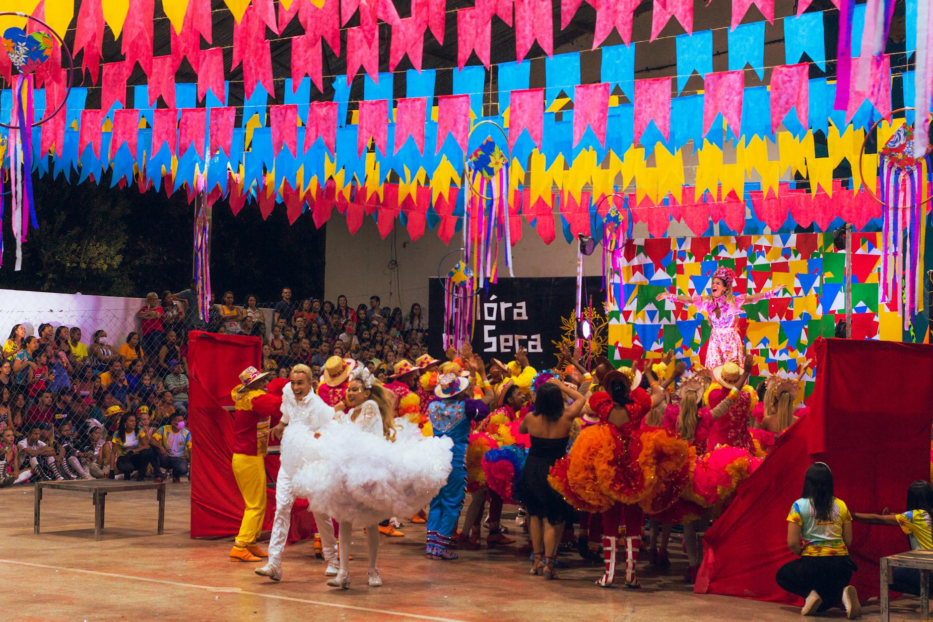 dancers on a stage under vibrant colour decoration